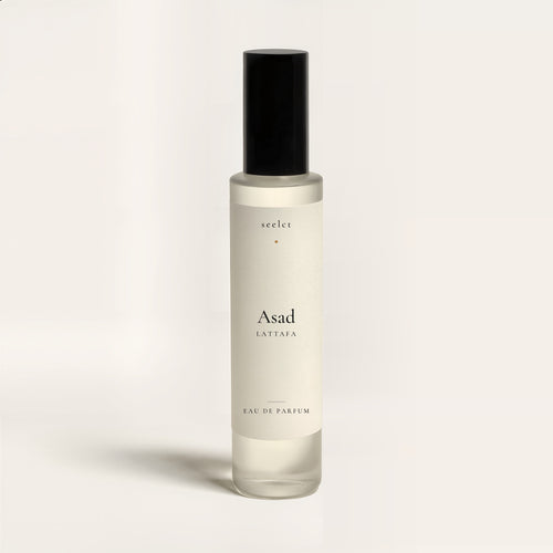 seelct sample vial of Asad by Lattafa, spicy woody fragrance, on bone background