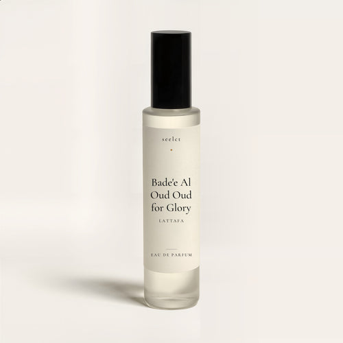 seelct sample vial of Bade'e Al Oud Oud for Glory by Lattafa, oud fragrance, on bone background