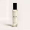 seelct sample vial of Khamrah Dukhan by Lattafa, smoky gourmand fragrance, on bone background